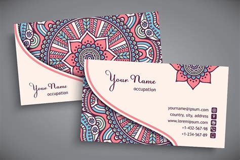 two business cards with an ornate design on the front and back, both in ...