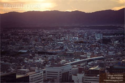 Photo of Kyoto aerial sunset city scenery landscape with departing Shinkansen train and ...