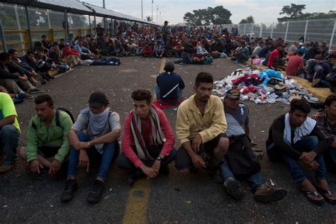 The Latest: Migrants wait to cross border with Mexico