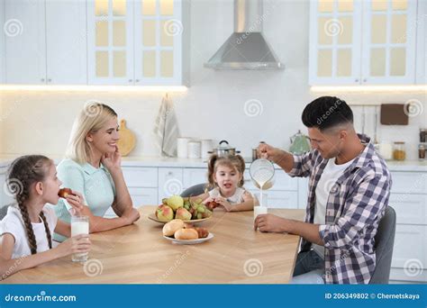 Happy Family Eating Together at Table in Modern Kitchen Stock Photo - Image of modern, dinner ...