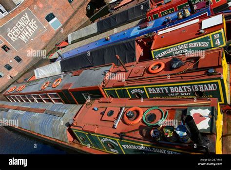 Many colourful canal boats are moored in Gas Street Basin on Birmingham ...