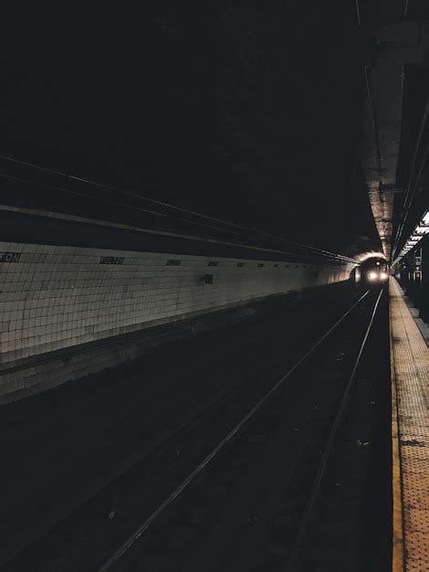 Premium Photo | Railway tracks at railroad station at night