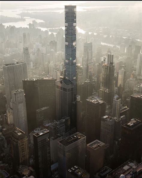 an aerial view of a city with skyscrapers in the foreground and water ...