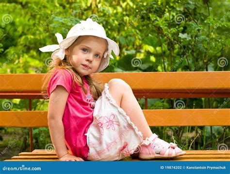 Little Girl Sitting on the Bench Stock Photo - Image of garden, activity: 19874202