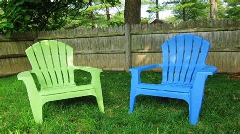 two plastic lawn chairs sitting in the grass