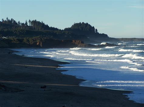 an ocean beach with waves crashing on the shore