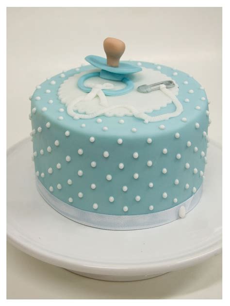 Blue fondant with raised dots topped with a pacifier ...A beautiful ...