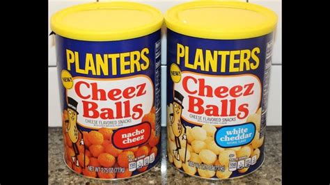 two cans of planters cheez balls sitting on a counter