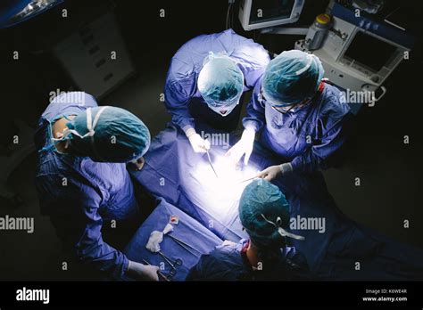 Top view shot of team of surgeons performing surgery in operation ...