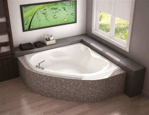 a bathroom with a large jacuzzi tub next to a window on the wall