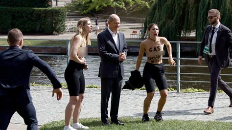 Germany: Topless protesters interrupt Olaf Scholz speech as fuel crisis ...