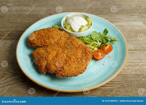 Schnitzel, Fried Chicken with Cucumber Salad and Vegetables Stock Photo ...