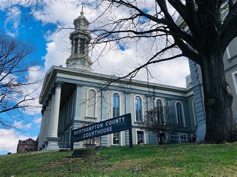 a large building with a steeple on top and a street sign in front of it