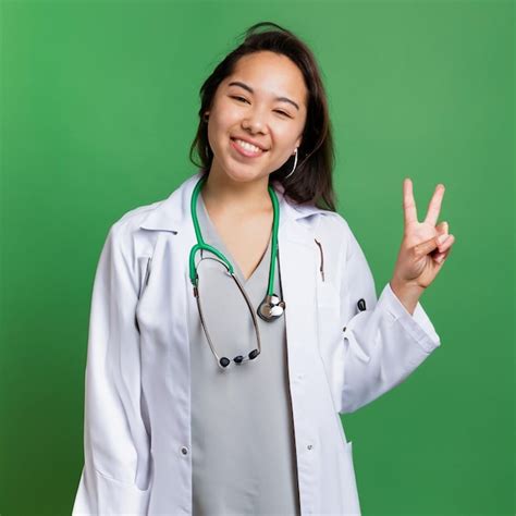 Premium AI Image | A female doctor in a white coat gives a peace sign