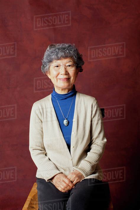 Older Japanese woman smiling - Stock Photo - Dissolve