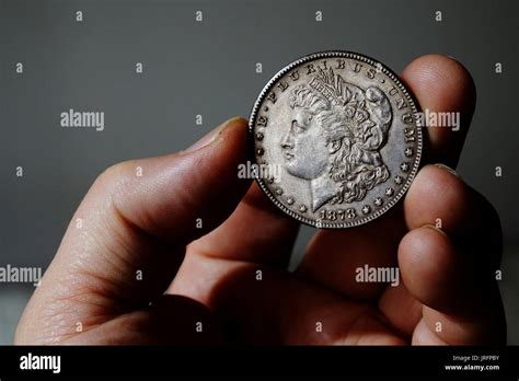 the old silver American dollar of 1878 in hand Stock Photo - Alamy