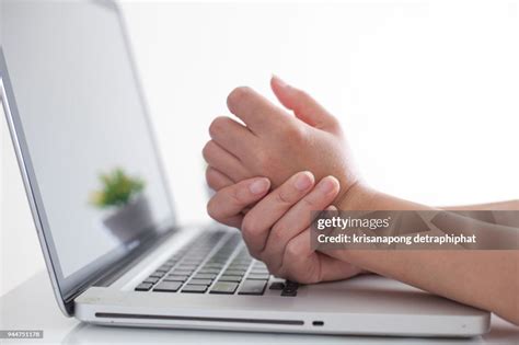 Woman Holding Her Wrist Pain From Using Computer Hand Pain High-Res Stock Photo - Getty Images