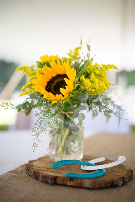 Centerpieces of Sunflowers in Mason Jars on Wood Slabs