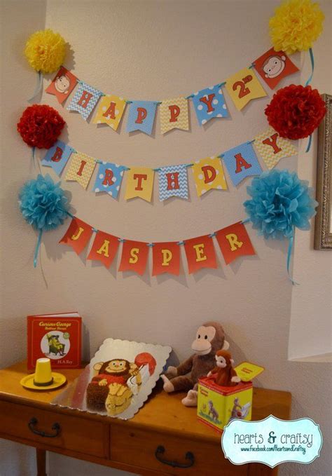 there is a birthday banner on the wall next to a table with books and toys