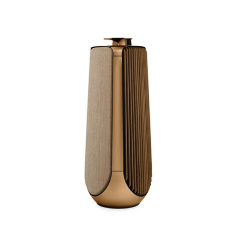 a gold vase sitting on top of a white surface
