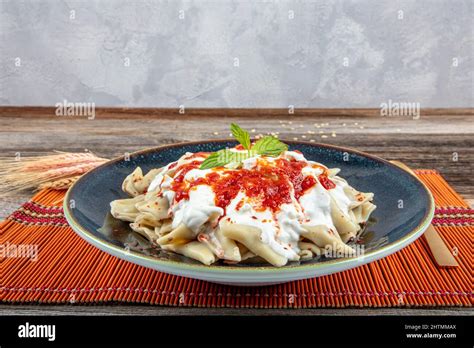 Plates of traditional Turkish food. Turkish Ravioli (Mantı) with yoghurt and tomato sauce Stock ...