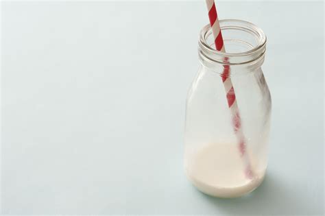 Free Stock Photo 12999 Lone glass bottle nearly emptied of white milk | freeimageslive