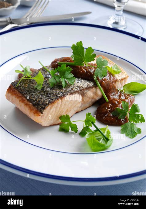 Marco Pierre White recipe salmon fillet with tomato sauce and herbs Stock Photo - Alamy