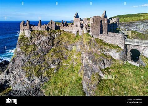 Ruins of medieval Dunluce Castle, cliffs, bays and peninsulas. Northern coast of County Antrim ...