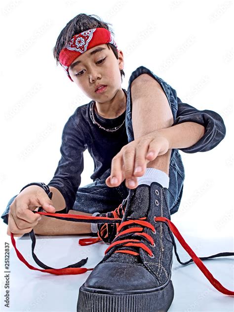 boy tying his shoe laces isolated on white background Stock Photo | Adobe Stock