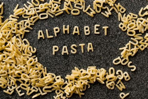 Raw Alphabet Pasta is Written with Letters on Granit Grey Surface. Stock Image - Image of ...