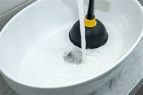 Plunger and clogged sink stock image. Image of dislodge - 238600215