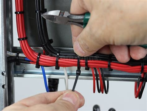 Installation of a Cable Tie on an Insulated Mounting Wire in an Electrical Panel. Stock Image ...