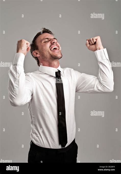 Young man wearing a shirt and a tie cheering, success, victory pose Stock Photo: 60289581 - Alamy