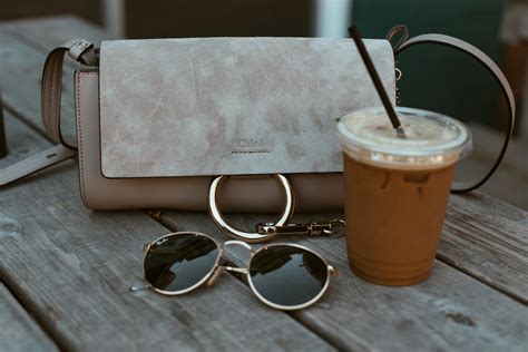 Leather Crossbody Bag Beside Drink And Sunglasses · Free Stock Photo