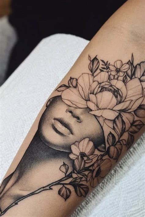 a woman's face with flowers on her arm