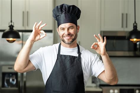 Premium Photo | Handsome man chef in uniform cooking in the kitchen ...