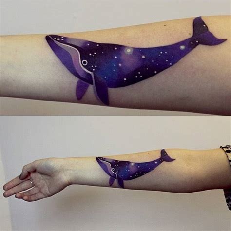 Space whale tattoo on the right inner forearm.