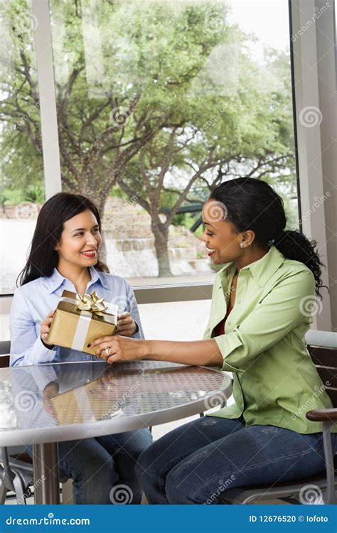 Woman Giving Female Friend a Gift Stock Photo - Image of birthday, occasion: 12676520