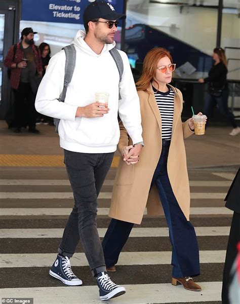 Brittany Snow holds hands with fiance Tyler Stanaland as they arrive at ...