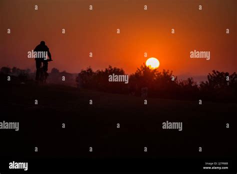 silhouette bike on sunset and bicycle background Stock Photo - Alamy