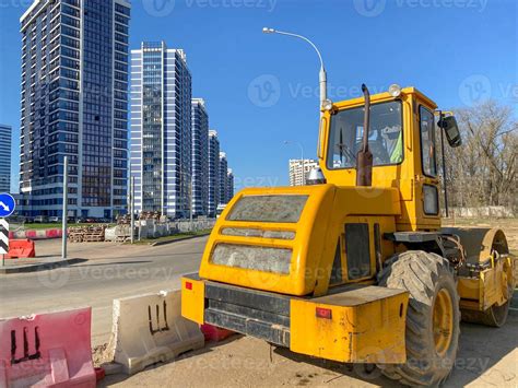 Large powerful modern yellow roller for asphalt paving, repair and road ...