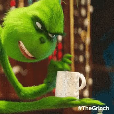 the grinch character is holding a coffee cup