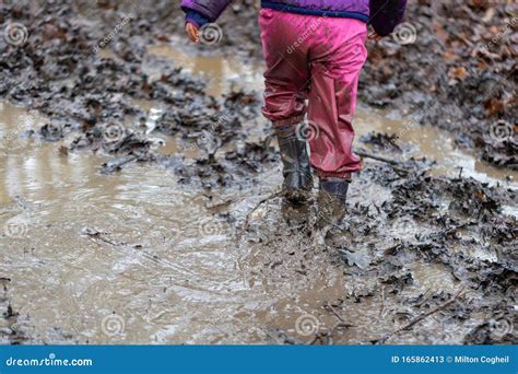 Young Children Playing in a Mud Puddle Stock Image - Image of playful, happy: 165862413