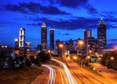 USA, Georgia, Atlanta, City skyline at dusk - Stock Photo - Dissolve