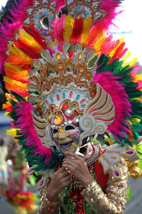 A COLORFUL HEADDRESS AND MASK WORN by a dancer of the MassKara Festival, an annual celebration ...