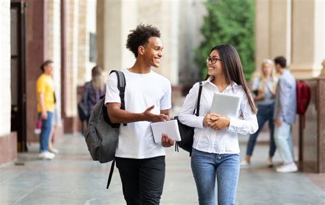 College friends walking in campus and talking - GradePower Learning