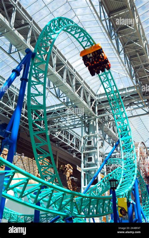 A looping roller coaster sends thrill seekers upside down at an indoor amusement park in the ...