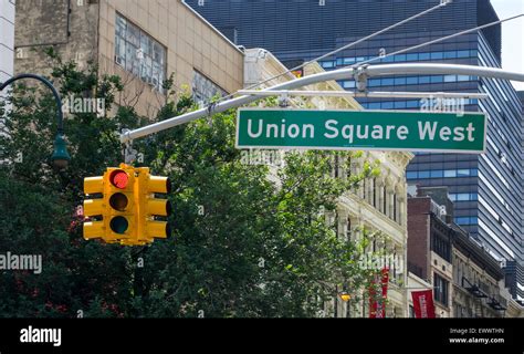 Union Square West street sign and red traffic light in New York City ...