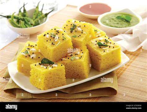 popular Indian / Gujarati dish Traditional Street Food Sev Khaman Dhokla Served With Chutney ...