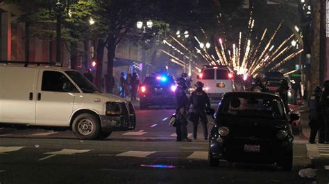 Portland riots: Officers injured after protesters launch fireworks at them - CNN